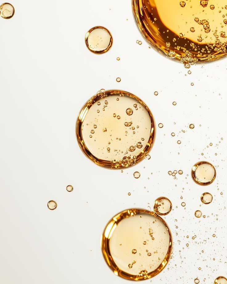 Gold bubbles on a light gray background