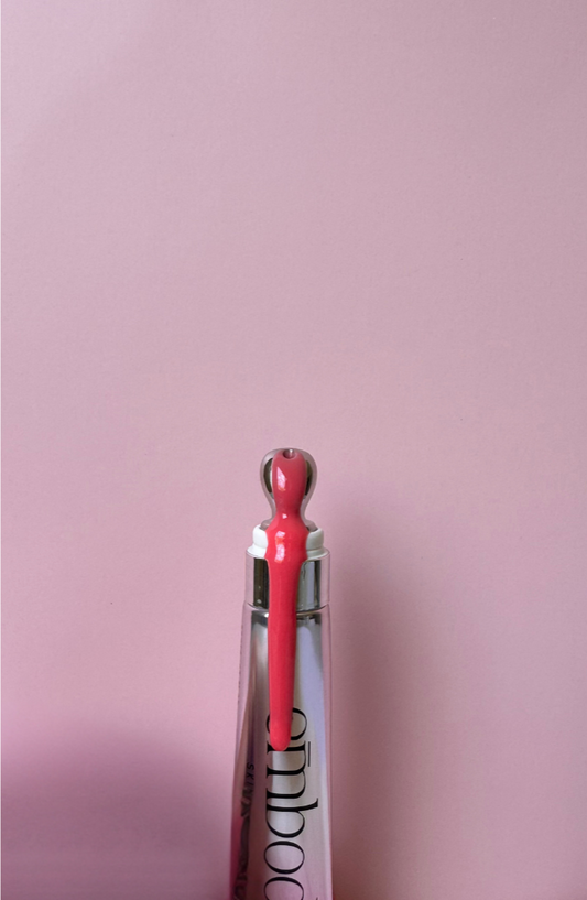 Lip oil in sleek applicator bottle for moisturised and shiny finish
